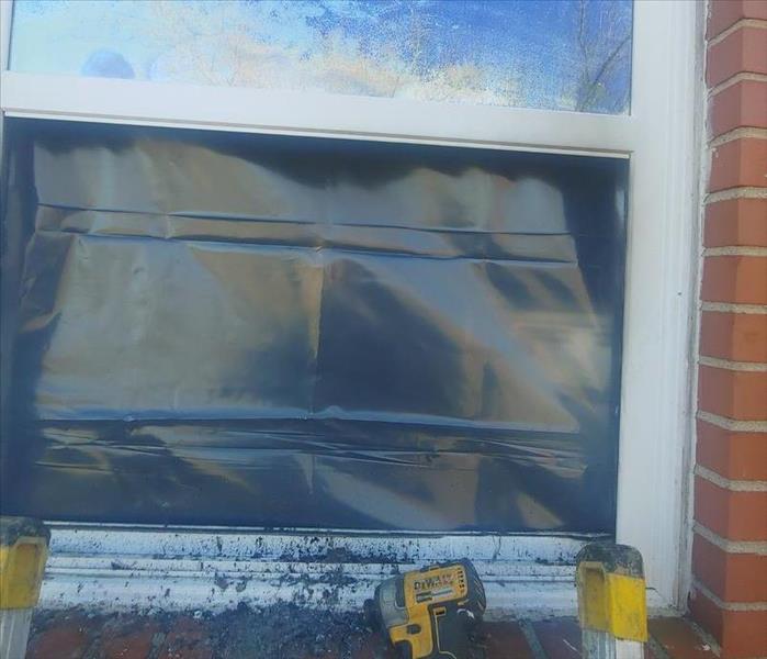 Window Damaged due to fire in the kitchen covered from the inside with plastic