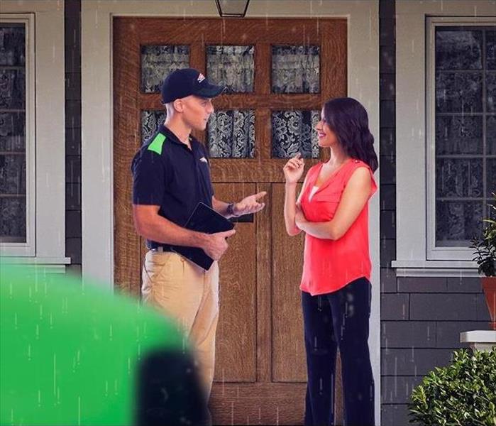SERVPRO employee speaking with a homeowner